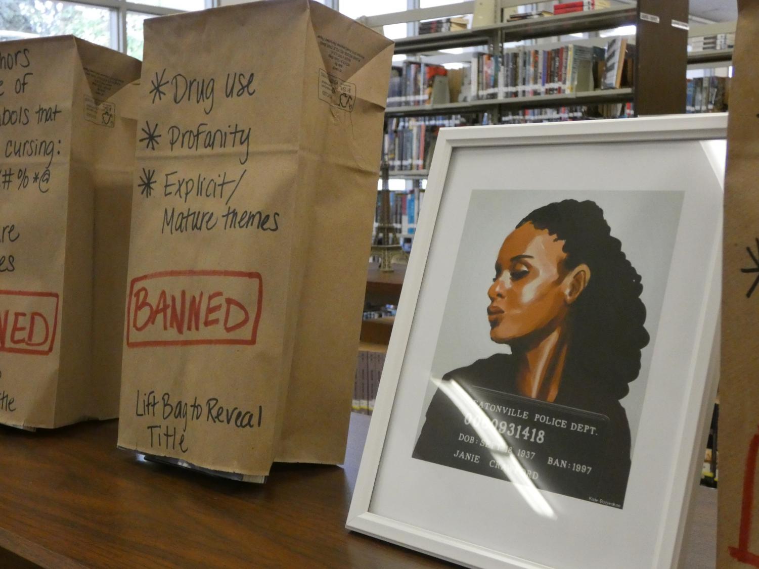 The RHS librarys Banned Book Week display showed students the wide variety of books, like Milk and Honey, that have been banned over the years across the nation. A mugshot drawing of Janie Crawford, a character from another banned book, Their Eyes Were Watching God shares the shelf with the brown paper bag that hides her story.